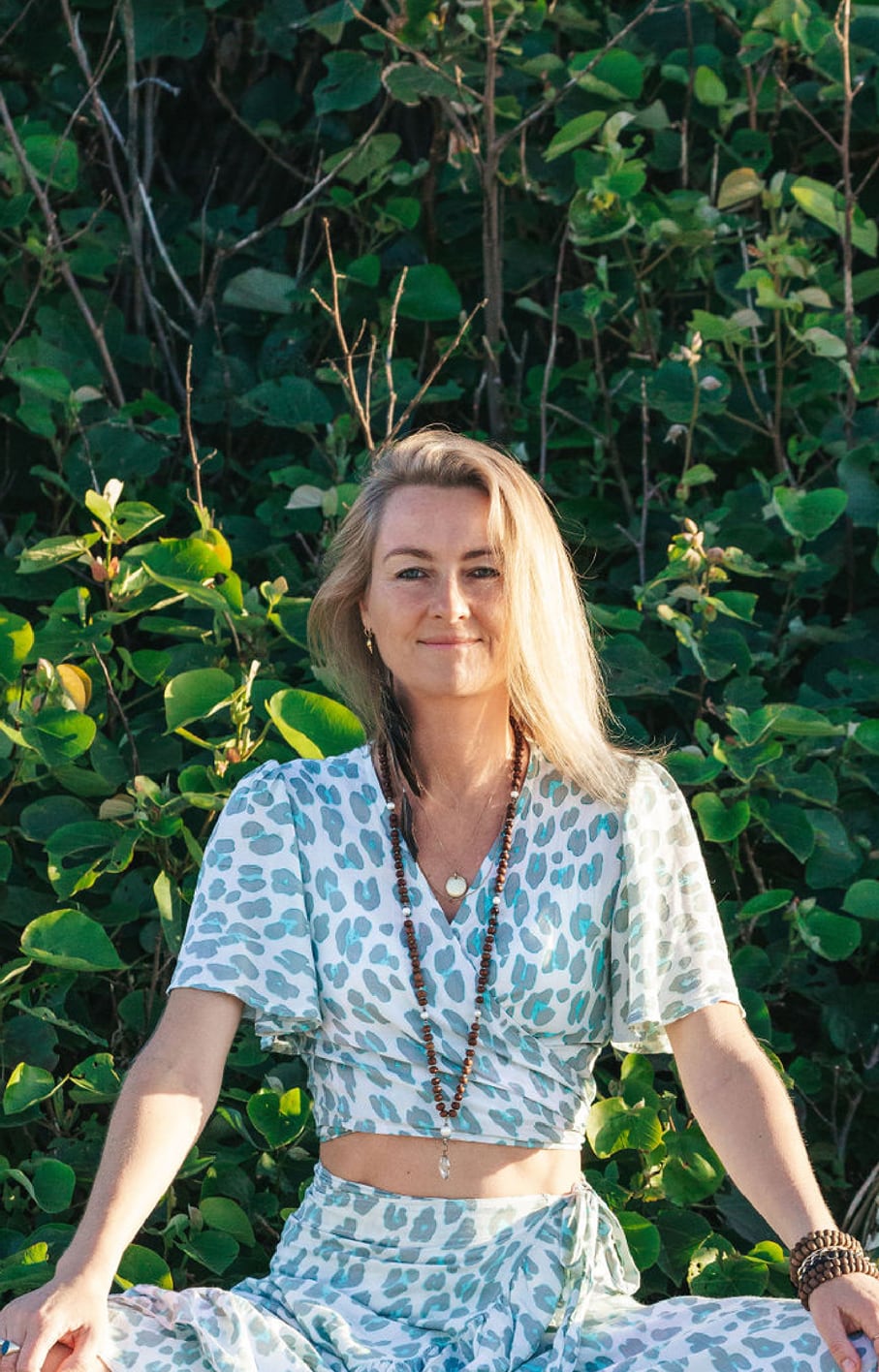 Laurentine sitting in front of the bush